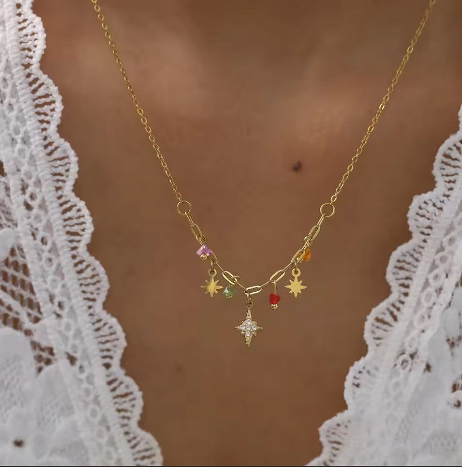 Gold necklace with colorful charms on a model